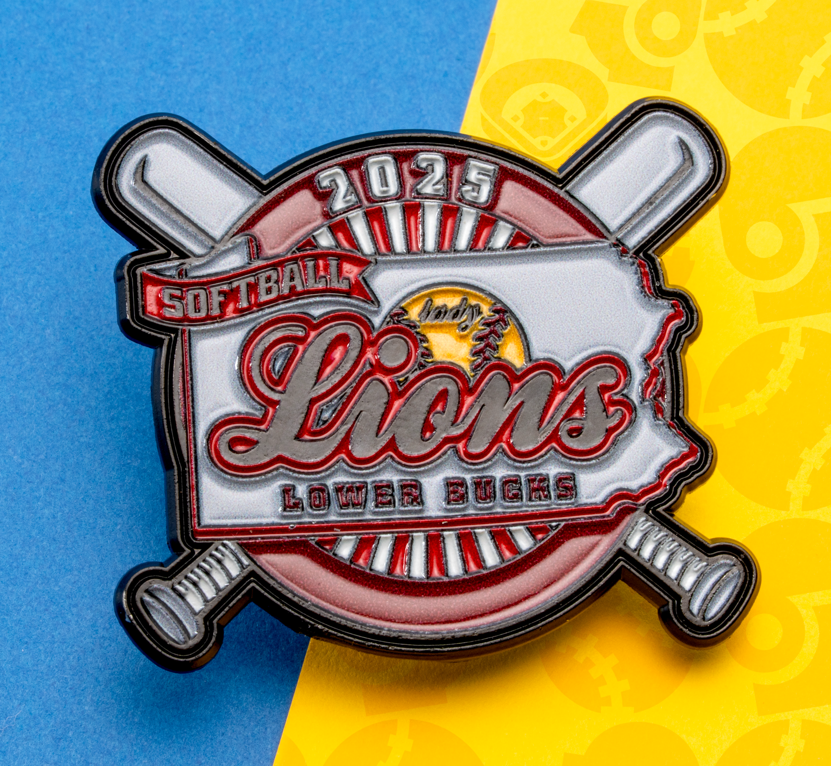 Softball lapel pin with '2025 Lady Lions Lower Bucks' text over a Pennsylvania state outline and crossed bats.