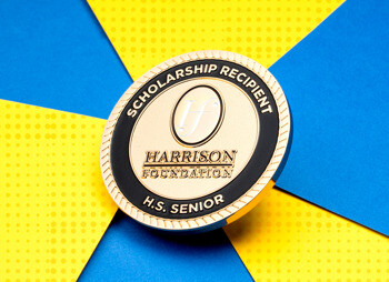Gold and black Harrison Foundation Scholarship Recipient challenge coin for high school seniors.