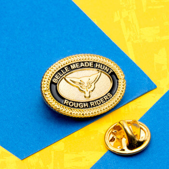 Gold oval lapel pin with black enamel border featuring Belle Meade Hunt Rough Riders text and a fox head emblem.