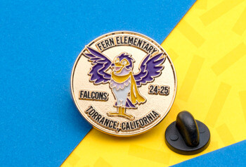 Round gold lapel pin for Fern Elementary Falcons in Torrance, California featuring a purple and yellow falcon mascot.