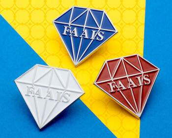 Three diamond-shaped FAAIS lapel pins in blue, white, and red with silver outlines on a blue and yellow background.