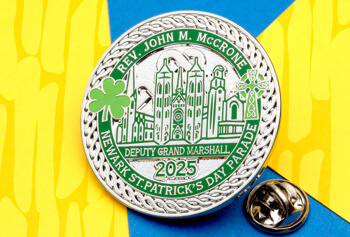 Green and silver lapel pin for the 2025 Newark St. Patrick's Day Parade featuring Rev. John M. McCrone, a shamrock, and a cathedral.