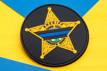 PVC patch featuring a yellow five-point sheriff star with a thin blue line on a black circular background.