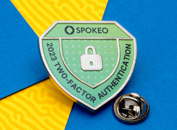 Shield-shaped Spokeo Two-Factor Authentication lapel pin with a lock icon and green enamel on a blue and yellow background.
