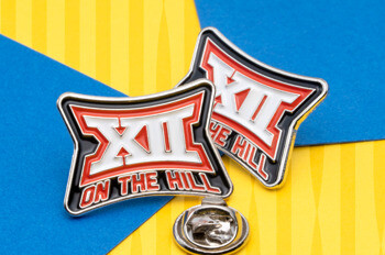 Two enamel lapel pins featuring the Big 12 logo and the text On the Hill in red, white, and black on a blue and yellow background.