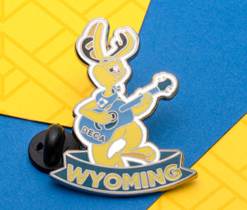 Enamel lapel pin featuring a yellow jackalope playing a guitar with the word Wyoming on a banner.