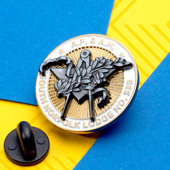 South Norfolk Lodge No. 339 Masonic lapel pin with square and compasses design over a gold and silver background, shown with its black rubber clutch.