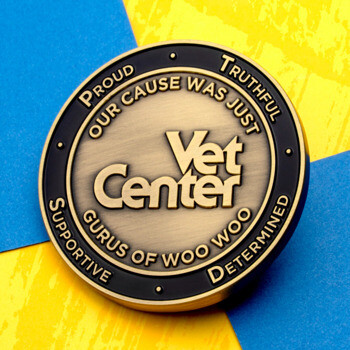 Antiqued bronze Vet Center challenge coin with black enamel border, featuring the text Our Cause Was Just, Gurus of Woo Woo, and Supportive, Truthful, Determine